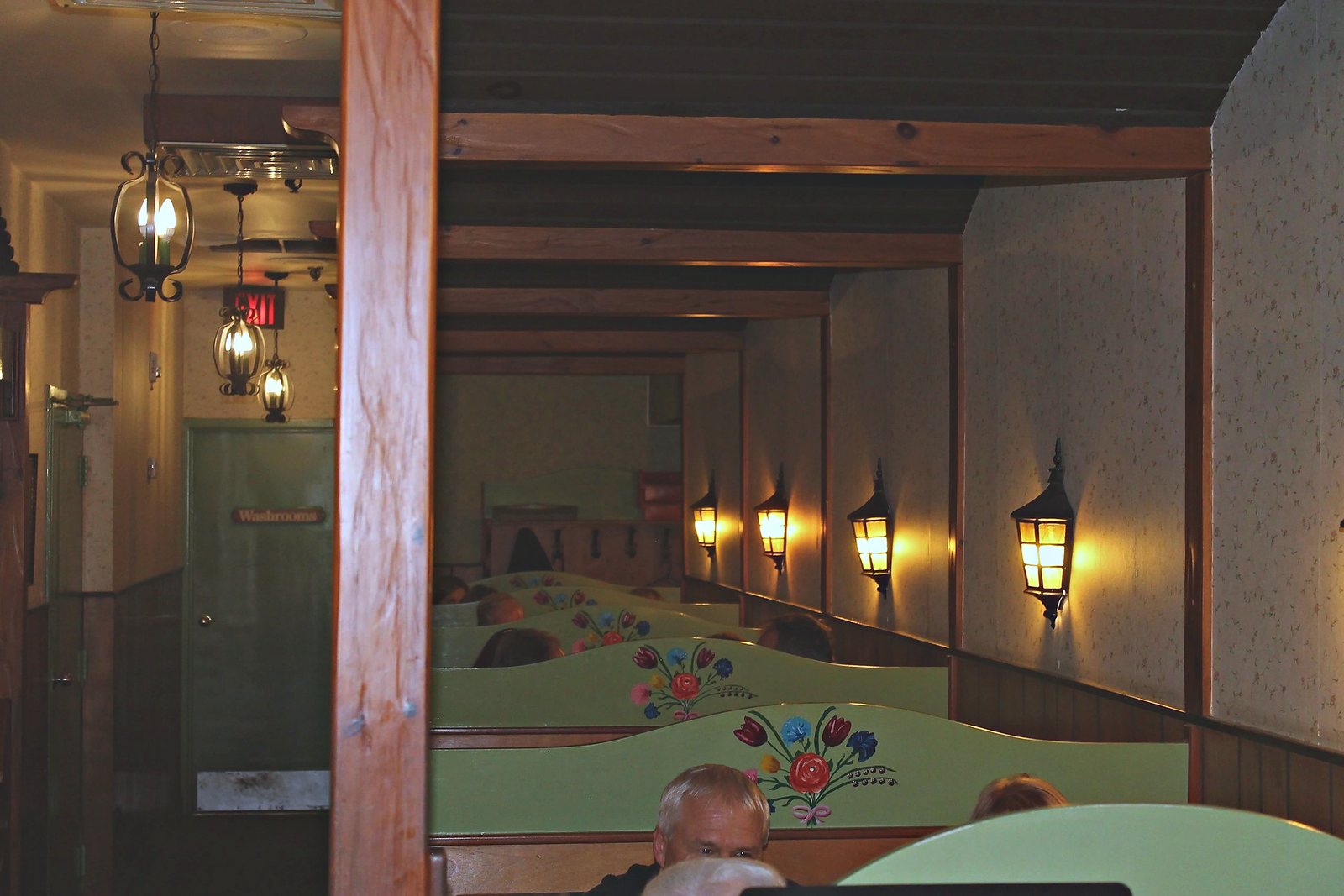 Lantern-lit hallway between the booths