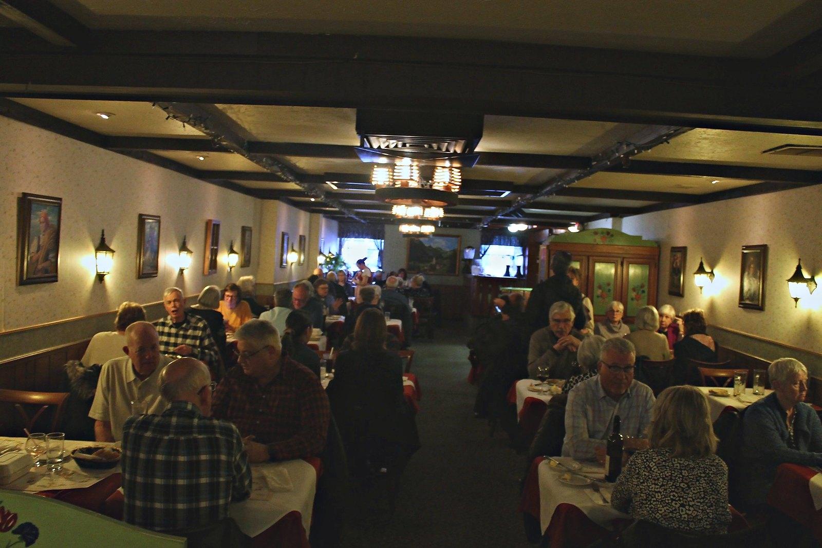 A full dining room under warm lamplight